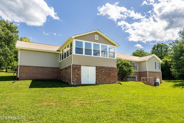178 Scenic Hill Ln, Lenoir City, TN 37771 - rear view of property with brick siding, a lawn, a sunroom, and central AC