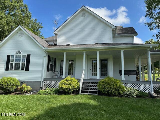 133 Coolidge Rd, Lafollette, TN 37766 - country-style home with a porch and a front yard
