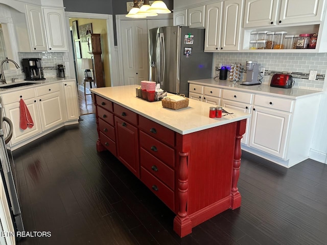 133 Coolidge Rd, Lafollette, TN 37766 - kitchen featuring a sink, stainless steel fridge with ice dispenser, decorative backsplash, dark wood-type flooring, and white cabinets