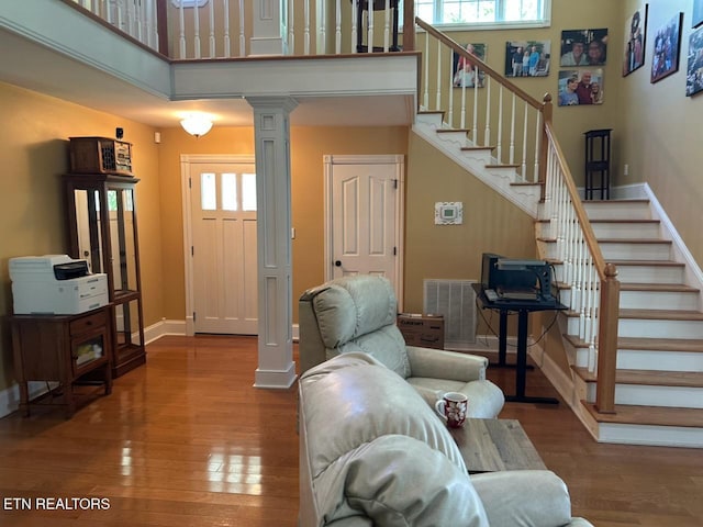 133 Coolidge Rd, Lafollette, TN 37766 - living room with stairs, baseboards, ornate columns, and a towering ceiling