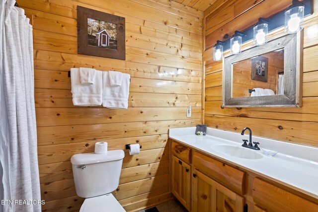 2819 White Oak Ridge Ln, Sevierville, TN 37862 - bathroom with wooden walls, vanity, and toilet