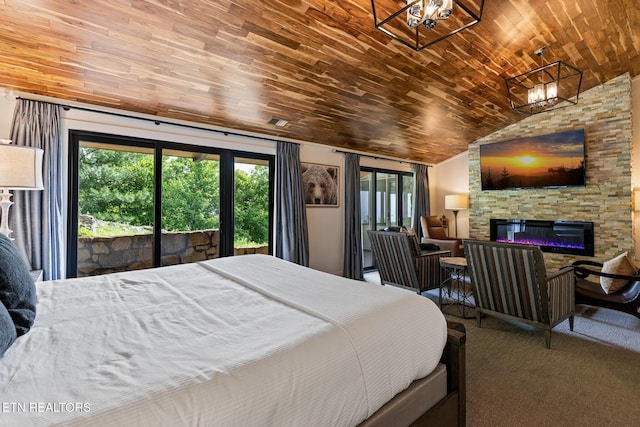 2940 Tower Rd, Sevierville, TN 37876 - carpeted bedroom featuring wooden ceiling, multiple windows, lofted ceiling, access to outside, and a stone fireplace