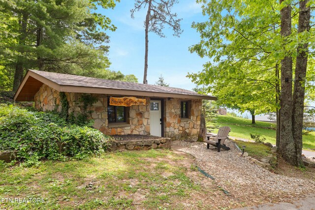 2940 Tower Rd, Sevierville, TN 37876 - view of front of house with stone siding, roof with shingles, and a front lawn