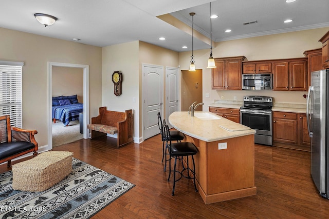4921 Willow Bluff Cir, Knoxville, TN 37914 - kitchen featuring stainless steel appliances, a sink, crown molding, a kitchen bar, and pendant lighting