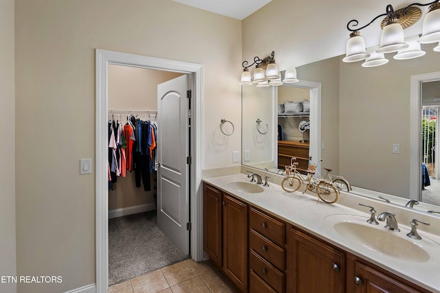 4921 Willow Bluff Cir, Knoxville, TN 37914 - full bathroom featuring double vanity, tile patterned floors, a walk in closet, and baseboards