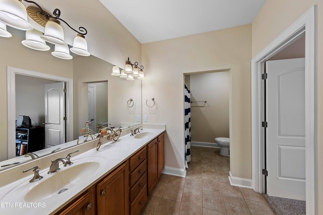 4921 Willow Bluff Cir, Knoxville, TN 37914 - full bath with double vanity, toilet, tile patterned floors, and baseboards