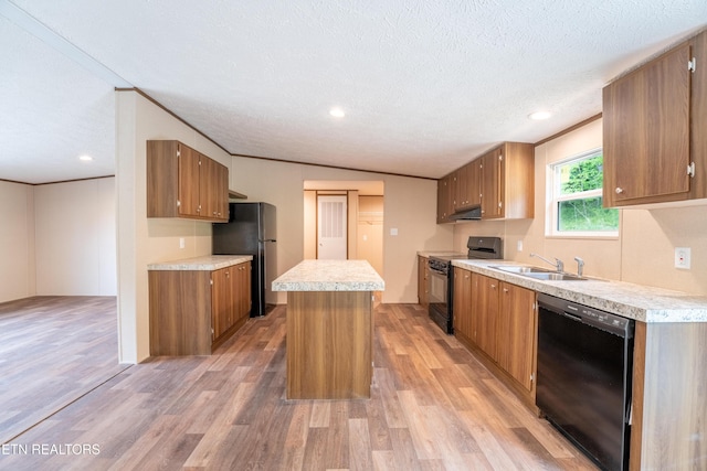 1587 Sweetwater Rd, Philadelphia, TN 37846 - kitchen with black appliances, a sink, light wood-style flooring, light countertops, and under cabinet range hood