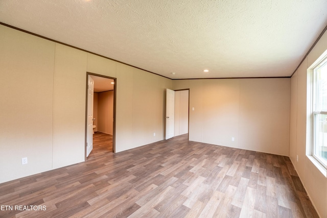 1587 Sweetwater Rd, Philadelphia, TN 37846 - spare room with wood finished floors, a textured ceiling, healthy amount of natural light, and ornamental molding