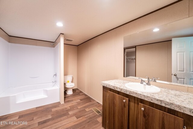 1587 Sweetwater Rd, Philadelphia, TN 37846 - bathroom featuring toilet, vanity, wood finished floors,  shower combination, and recessed lighting