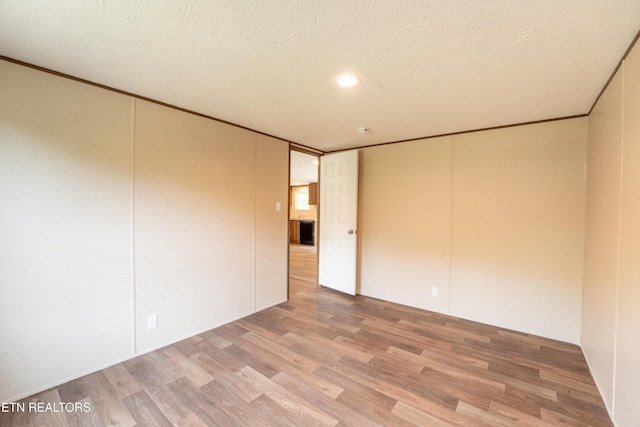 1587 Sweetwater Rd, Philadelphia, TN 37846 - unfurnished room featuring light wood-style flooring, a textured ceiling, and crown molding