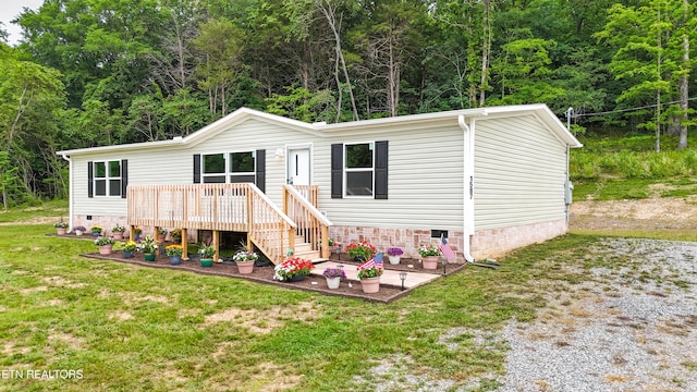 1587 Sweetwater Rd, Philadelphia, TN 37846 - view of front of property with crawl space, a front yard, a view of trees, and a wooden deck