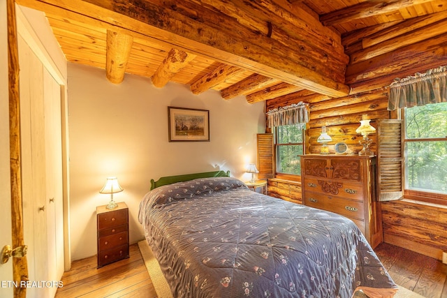 258 Marina Ln, Lafollette, TN 37766 - bedroom featuring wood ceiling with exposed beams, multiple windows, wood-type flooring, and rustic walls