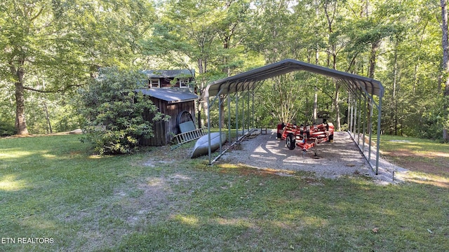 258 Marina Ln, Lafollette, TN 37766 - view of green lawn featuring a detached carport and a wooded view