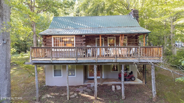 258 Marina Ln, Lafollette, TN 37766 - rear view of property featuring log siding, a chimney, a deck, and metal roof