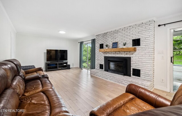 10628 Sandpiper Ln, Knoxville, TN 37922 - living area with ornamental molding, wood finished floors, a brick fireplace, and baseboards