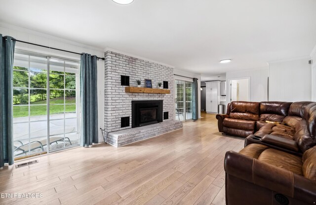10628 Sandpiper Ln, Knoxville, TN 37922 - living room with crown molding, light wood finished floors, and a brick fireplace