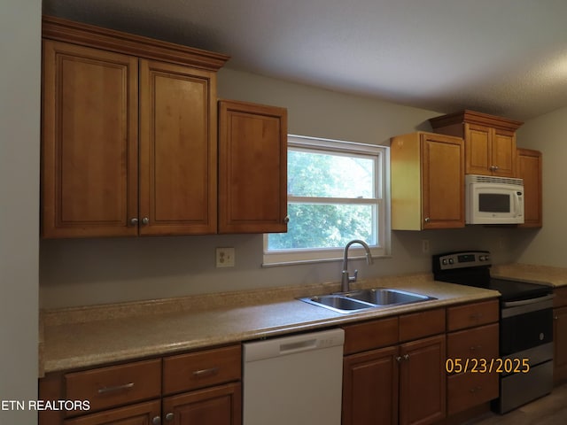 5820 Rockwood Ln, Knoxville, TN 37921 - kitchen with white appliances, a sink, light countertops, and brown cabinets