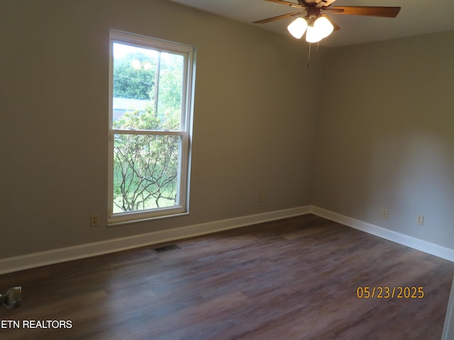 5820 Rockwood Ln, Knoxville, TN 37921 - spare room featuring plenty of natural light, ceiling fan, dark wood-style floors, and baseboards