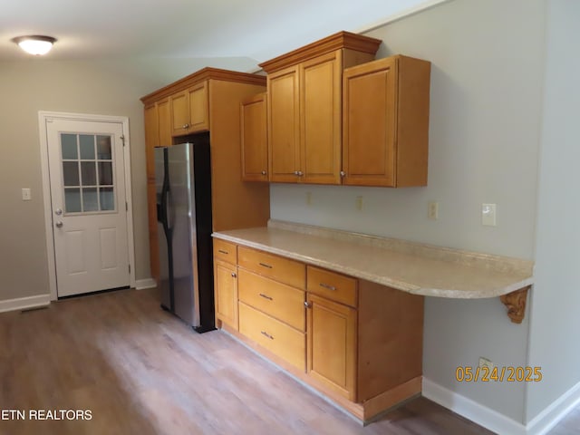 5820 Rockwood Ln, Knoxville, TN 37921 - kitchen featuring stainless steel fridge with ice dispenser, light wood finished floors, light countertops, and brown cabinetry