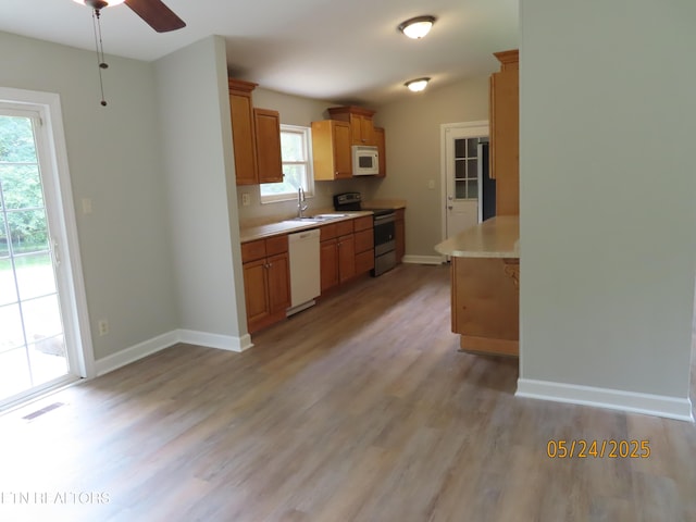 5820 Rockwood Ln, Knoxville, TN 37921 - kitchen with white appliances, light wood-type flooring, a sink, light countertops, and a ceiling fan