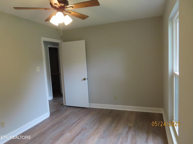5820 Rockwood Ln, Knoxville, TN 37921 - unfurnished room featuring wood finished floors, a ceiling fan, and baseboards