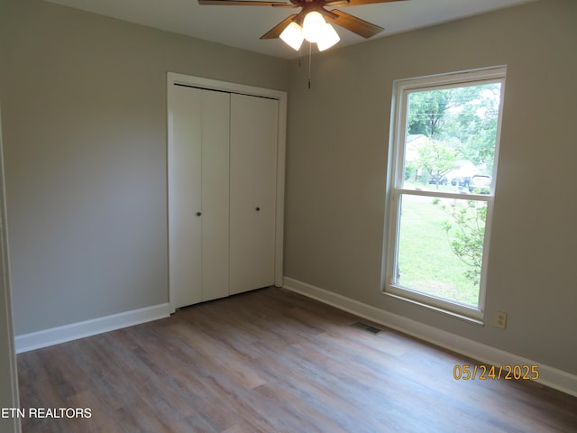 5820 Rockwood Ln, Knoxville, TN 37921 - unfurnished bedroom with wood finished floors, a closet, and baseboards