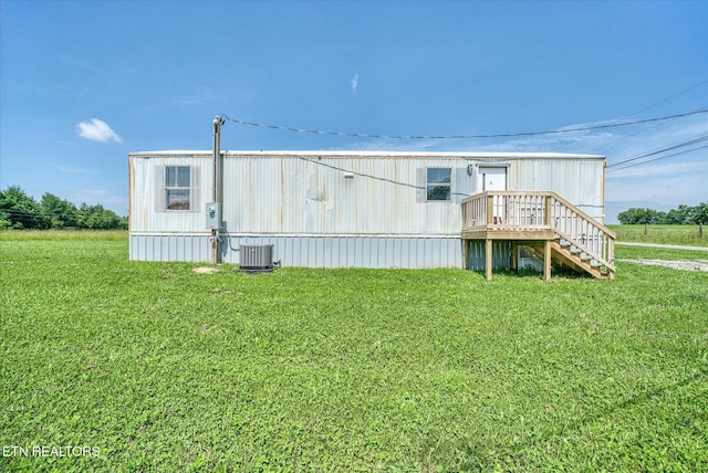 170 Bob Austin Rd, Crossville, TN 38571 - view of home's exterior featuring central air condition unit, a yard, and stairs