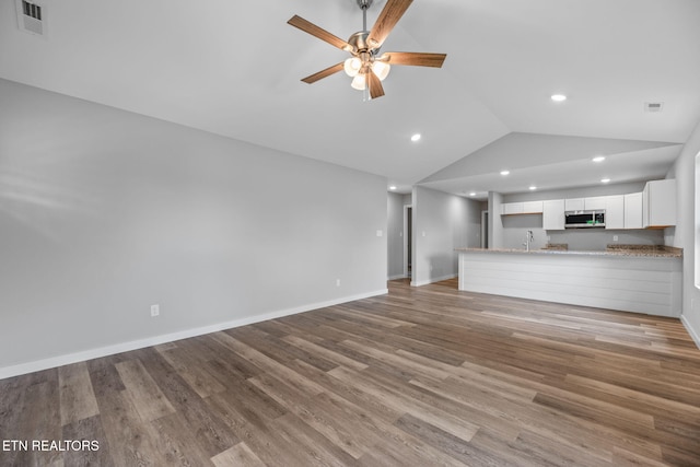 319 S Elmwood St, Knoxville, TN 37914 - unfurnished living room with vaulted ceiling, a sink, a ceiling fan, light wood finished floors, and recessed lighting