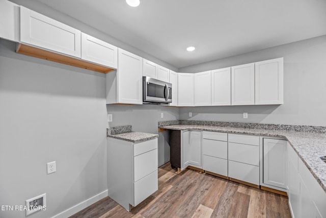 319 S Elmwood St, Knoxville, TN 37914 - kitchen with stainless steel microwave, light stone countertops, white cabinetry, wood finished floors, and recessed lighting