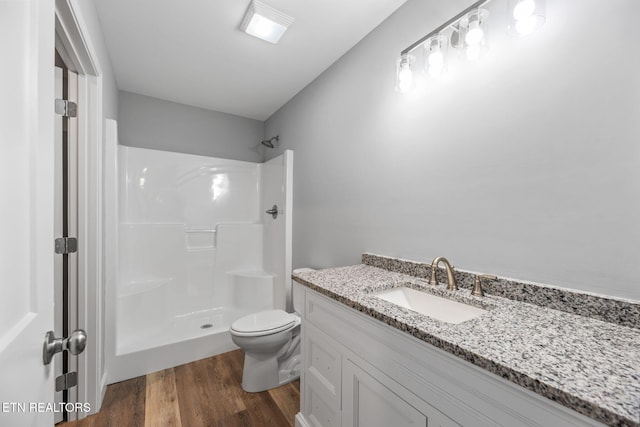 319 S Elmwood St, Knoxville, TN 37914 - bathroom with a shower, toilet, vanity, and wood finished floors