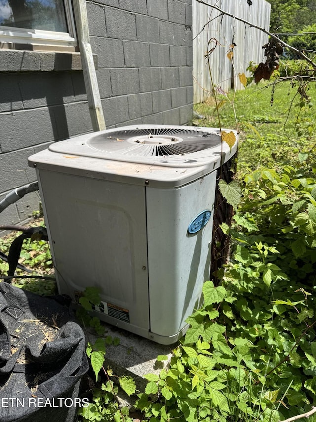 142 W Wadsworth Cir, Oak Ridge, TN 37830 - exterior view of central AC unit and concrete block siding