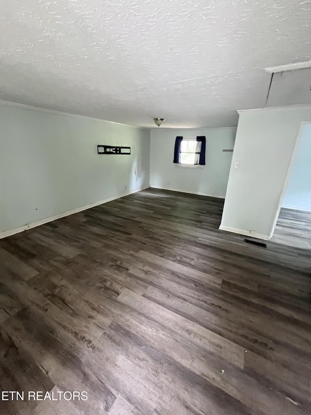 142 W Wadsworth Cir, Oak Ridge, TN 37830 - unfurnished living room featuring a textured ceiling, wood finished floors, and baseboards
