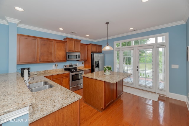 1101 Main St Unit 19, Loudon, TN 37774 - kitchen with appliances with stainless steel finishes, brown cabinetry, french doors, light wood-style flooring, and hanging light fixtures