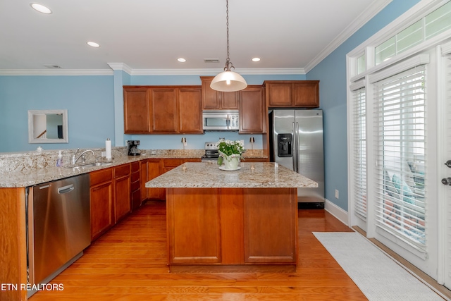 1101 Main St Unit 19, Loudon, TN 37774 - kitchen with stainless steel appliances, ornamental molding, light wood-style floors, a center island, and hanging light fixtures