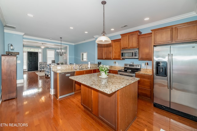 1101 Main St Unit 19, Loudon, TN 37774 - kitchen with appliances with stainless steel finishes, brown cabinets, a peninsula, ornamental molding, and open floor plan