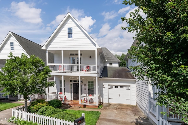 1101 Main St Unit 19, Loudon, TN 37774 - view of front facade featuring a balcony, covered porch, driveway, a garage, and roof with shingles