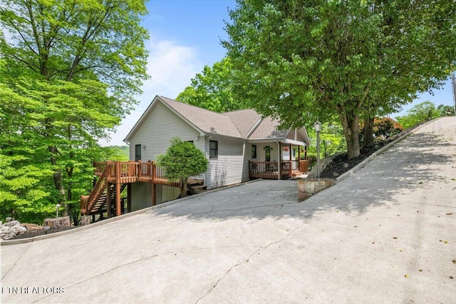 334 Little Buck Ln, Lafollette, TN 37766 - view of side of home with stairway, concrete driveway, a deck, and a porch