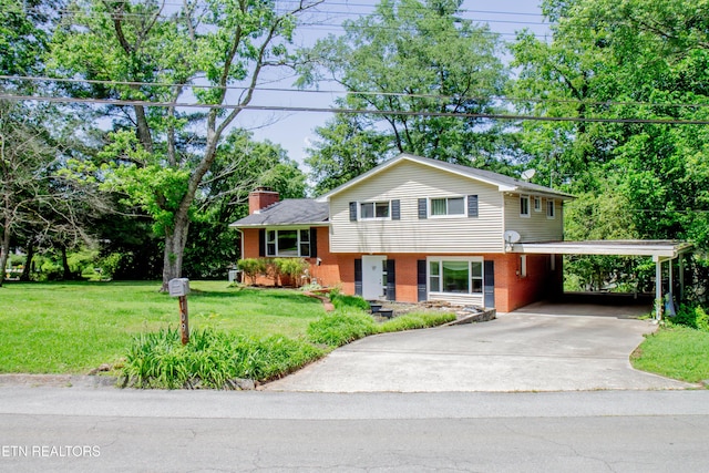 109 Cumberland View Dr, Oak Ridge, TN 37830 - view of front of home with brick siding, a chimney, driveway, a front lawn, and a carport