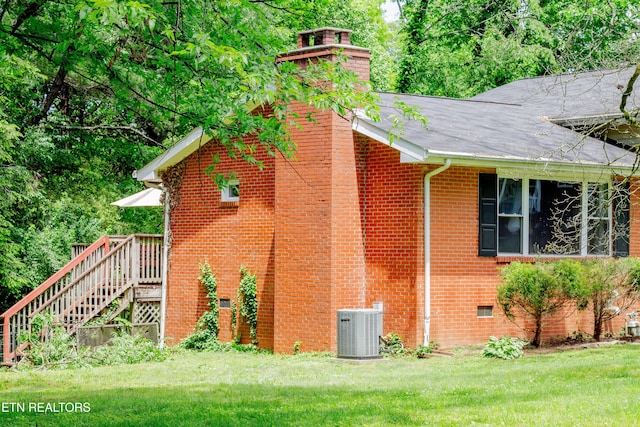 109 Cumberland View Dr, Oak Ridge, TN 37830 - view of side of home featuring cooling unit, brick siding, a chimney, and a lawn