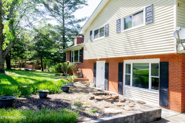 109 Cumberland View Dr, Oak Ridge, TN 37830 - view of property exterior featuring brick siding, a chimney, and a yard