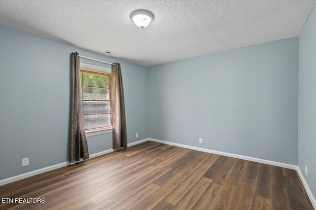 147 Cove Hollow Rd, Lafollette, TN 37766 - spare room with wood finished floors, a textured ceiling, and baseboards