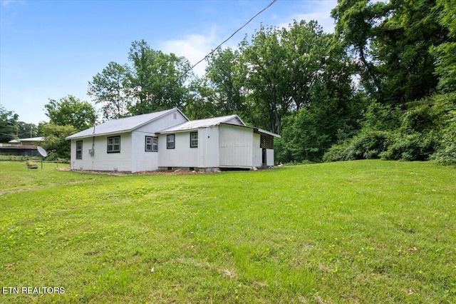 147 Cove Hollow Rd, Lafollette, TN 37766 - view of home's exterior featuring a lawn and metal roof