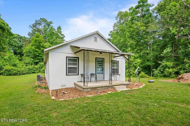 147 Cove Hollow Rd, Lafollette, TN 37766 - view of front of house with a porch, a front lawn, and central air condition unit