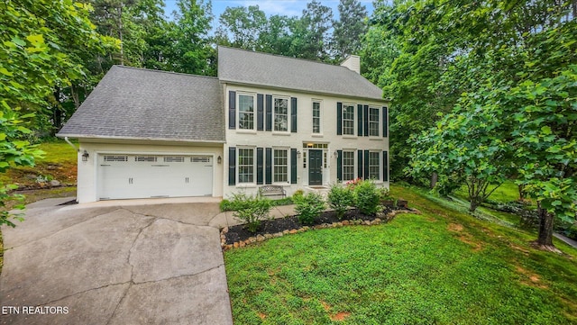 2819 Dee Peppers Dr, Knoxville, TN 37931 - colonial inspired home featuring a chimney, concrete driveway, roof with shingles, and an attached garage