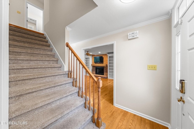 2819 Dee Peppers Dr, Knoxville, TN 37931 - stairs with wood finished floors, ornamental molding, a fireplace, baseboards, and a ceiling fan