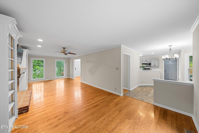 2819 Dee Peppers Dr, Knoxville, TN 37931 - unfurnished living room with a chandelier, light wood-style flooring, crown molding, recessed lighting, and ceiling fan