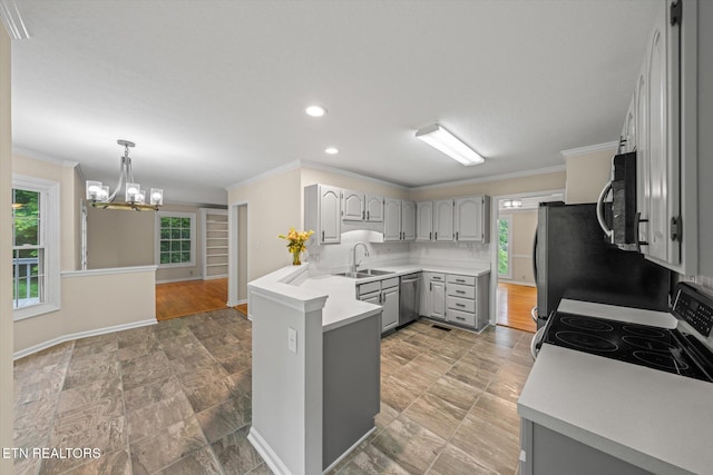 2819 Dee Peppers Dr, Knoxville, TN 37931 - kitchen with gray cabinets, appliances with stainless steel finishes, a sink, ornamental molding, and a chandelier