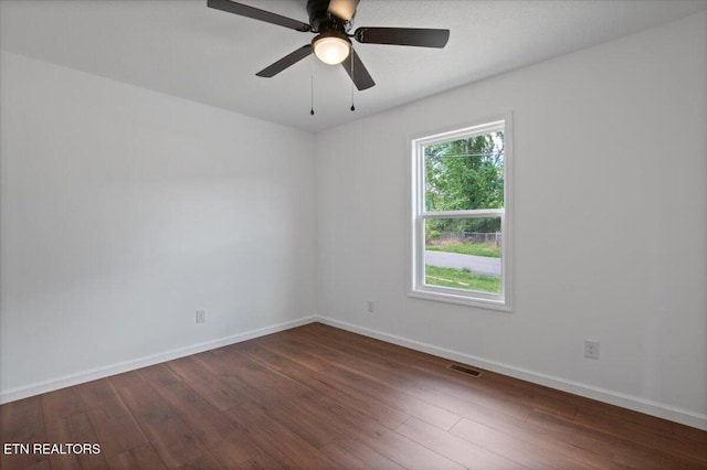 708 E Elm St, Lafollette, TN 37766 - unfurnished room featuring dark wood-style flooring, baseboards, and ceiling fan