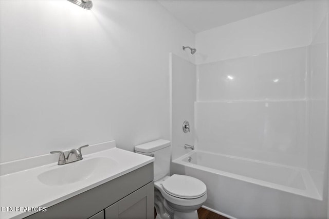 708 E Elm St, Lafollette, TN 37766 - bathroom with washtub / shower combination, toilet, vanity, and wood finished floors