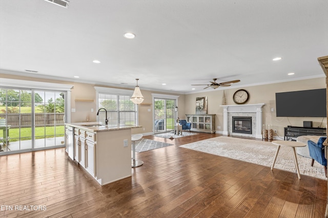 1017 Brighton Dr, Alcoa, TN 37701 - living room featuring a ceiling fan, a fireplace, wood finished floors, crown molding, and recessed lighting